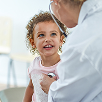 Female doctor examining a child with a stethoscope